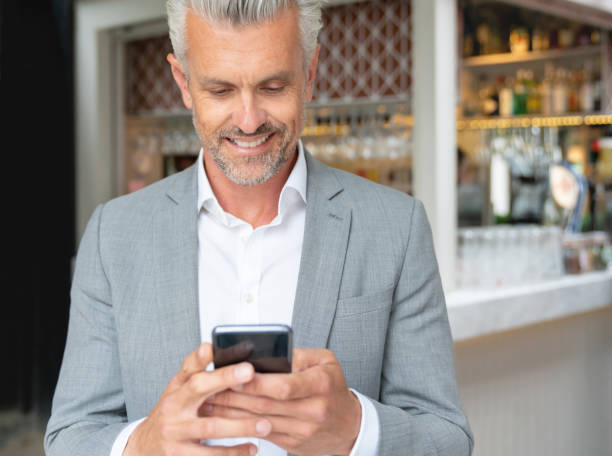 istock Business man texting on a mobile phone at a cafe 1067910482