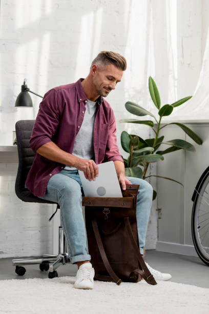 istock man putting the laptop in the bag 1067912778