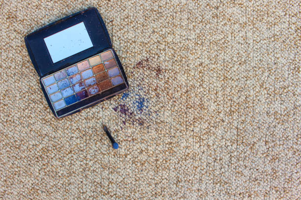 istock Eye shadow fell and scattered on carpet. Top view. 1067918200