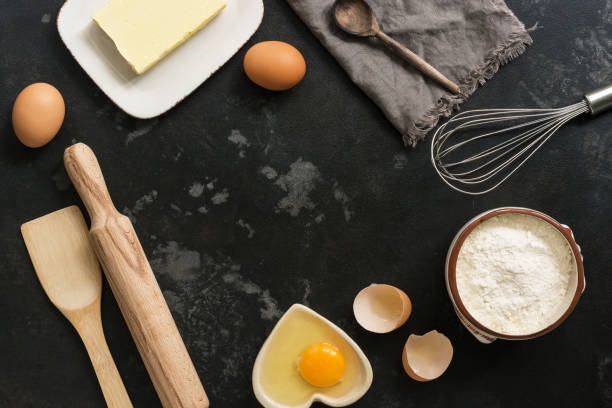 istock Ingredients for baking, flour, butter, eggs on a black stone background. Top view 1067918492