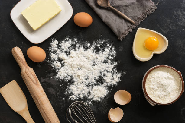 istock Ingredients for baking, flour, butter, eggs on a black stone background. Top view,copy space 1067918510