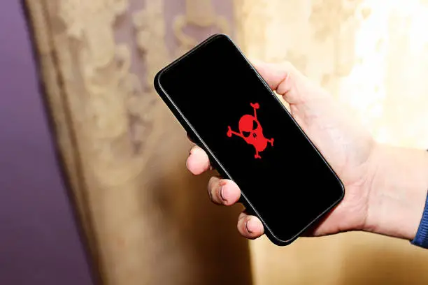Photo of Red pirate skull on smart phone screen