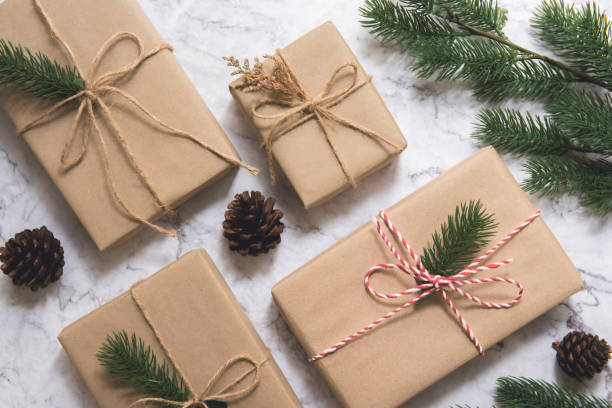 istock Christmas gift box and tree branch decor on marble background. 1067924494