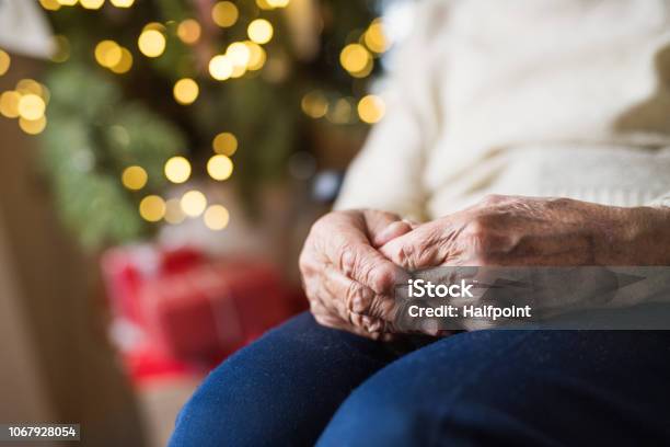 A Closeup Of A Senior Woman Sitting At Home At Christmas Time Stock Photo - Download Image Now