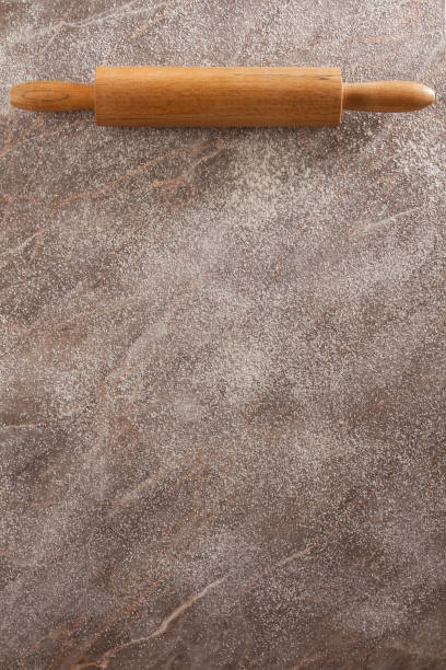 istock Rolling Pin on Woooden Floured Background 1067928492