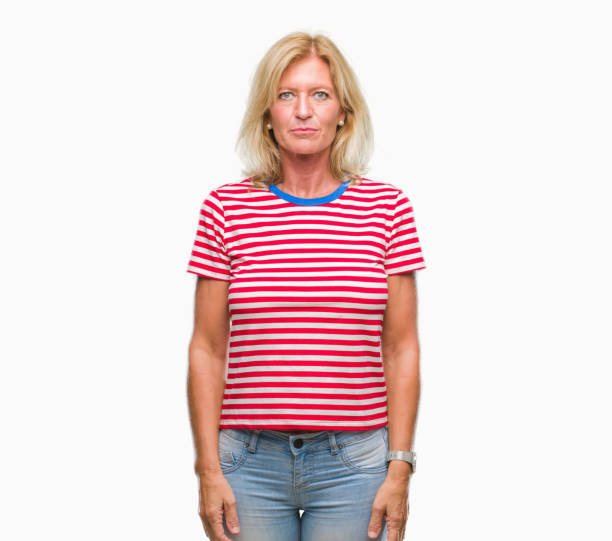 istock Middle age blonde woman over isolated background with serious expression on face. Simple and natural looking at the camera. 1067930848
