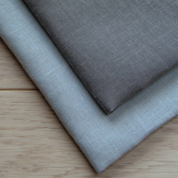 istock Grey towels pile isolated on wooden background. 1067938170