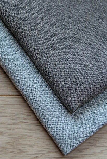 istock Grey towels pile isolated on wooden background. 1067938176