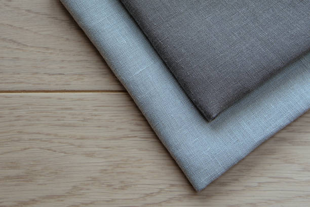 istock Grey towels pile isolated on wooden background. 1067938182