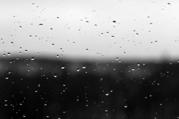 istock Rain drops and defocused sky background in black and white. 1067938554
