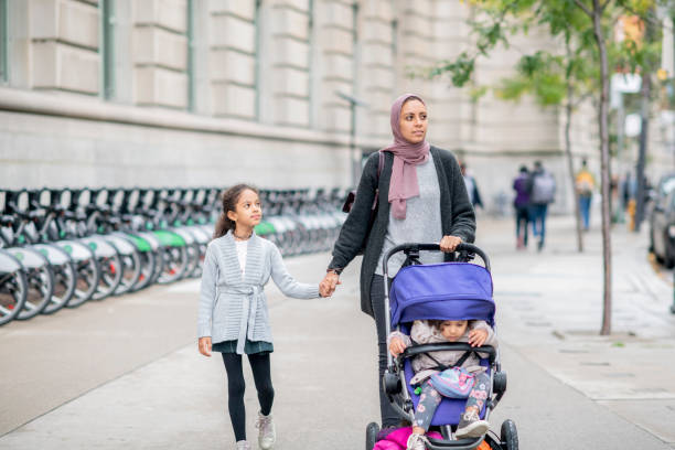 istock Muslim mother walking with kids 1067941562