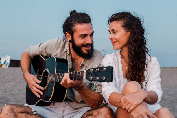 istock Couple in love playing guitar 1067941686