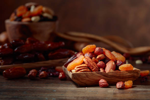 istock Various dried fruits and nuts in wooden dish. 1067944826