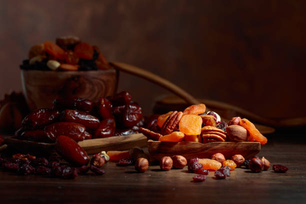istock Various dried fruits and nuts in wooden dish. 1067944850