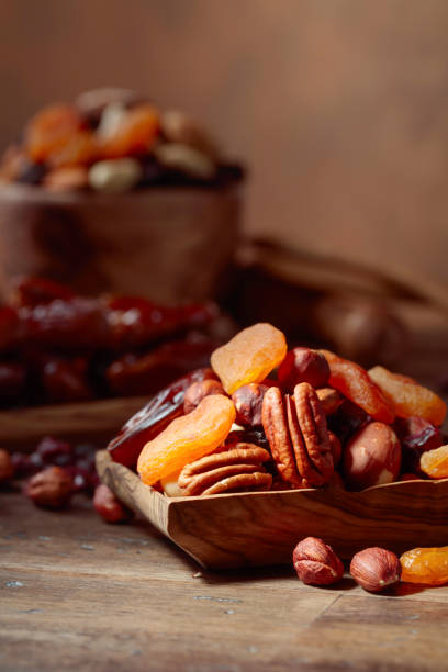 istock Various dried fruits and nuts in wooden dish. 1067944862