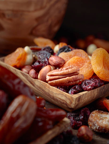 istock Various dried fruits and nuts in wooden dish. 1067944928