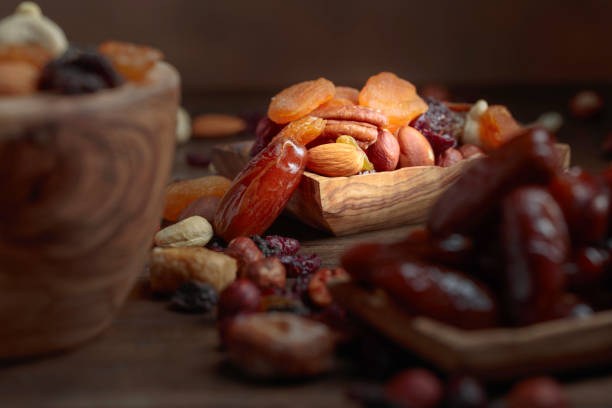 istock Various dried fruits and nuts in wooden dish. 1067944996
