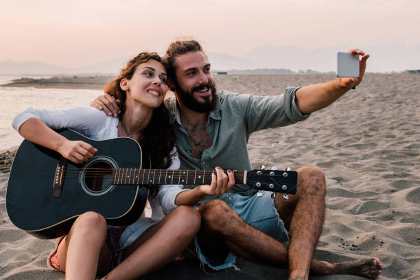 istock Couple taking a selfie at the beach 1067946970