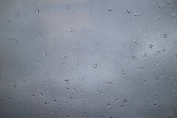 istock gray autumn sky drops on a window pane 1067947828