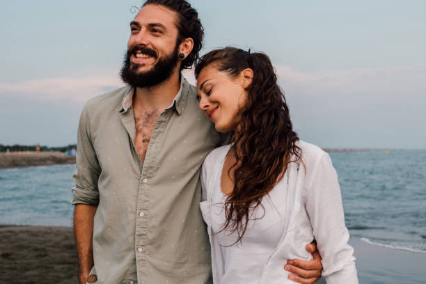istock Boyfriend and girlfriend walking at the beach 1067950842