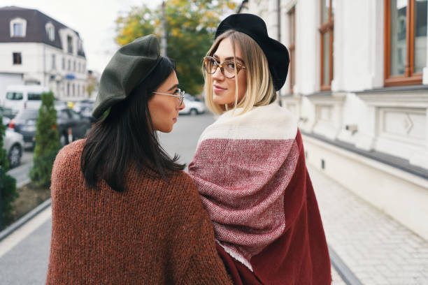 istock Pretty stylish girls looking over shoulder, smiling 1067956512