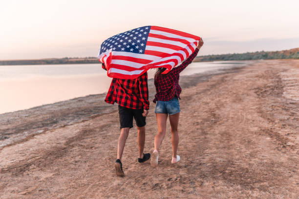 istock oung couple on the beach walking together 1067957950