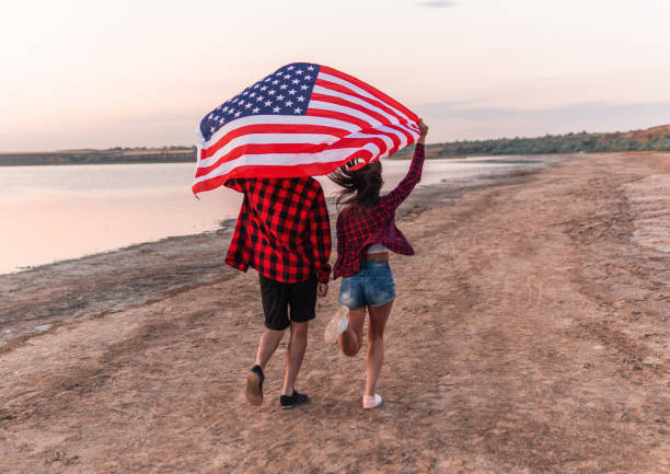 istock oung couple on the beach walking together 1067958144