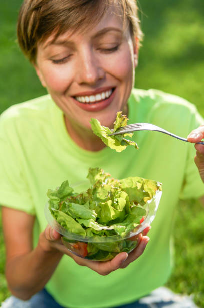 istock Caucasian woman eating salad 1067961092