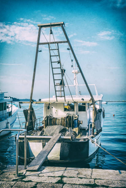 istock Fishing boat with nets in port, Porec, analog filter 1067961144