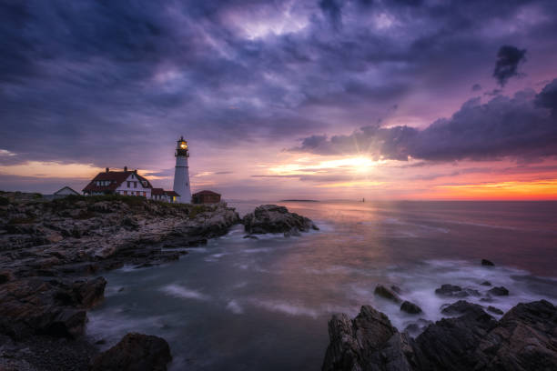 istock Sun shining through rain clouds at Portland Head Lighthouse 1067961954