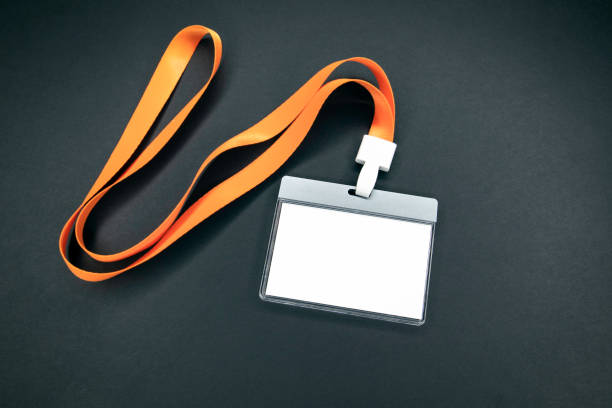 White empty staff identity mockup with orange lanyard White empty staff identity mockup with orange lanyard. Name tag, ID card. Black background pre press stock pictures, royalty-free photos & images