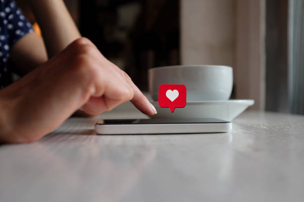 istock Young woman using smart phone with social media symbols 1067965416