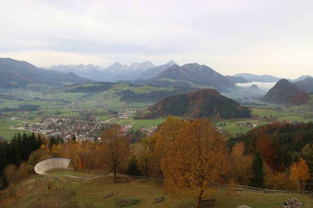 Panoramic view of autumn trees and the alps in Upper Austria. Panoramic view of autumn trees and the alps in Upper Austria, seen from the viewing tower Wurbauerkogel. From here, one has a fascinating view of the surrounding mountains. Europe. spital am pyhrn stock pictures, royalty-free photos & images