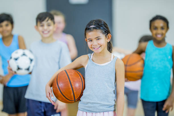istock Children smile holding balls 1067969206
