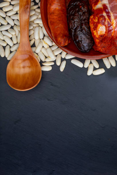 istock Appetizing spoon dish. Delicious for autumn, winter and all year. Asturian fabada, typical dish of Asturias (Spain). Stew of beans (white beans) with chorizo, bacon, black pudding, bacon, onion, garlic, parsley and salt. 1067974018