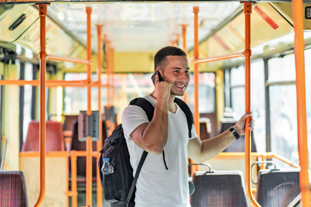istock Young Man in the Bus with Smart Phone 1067975126
