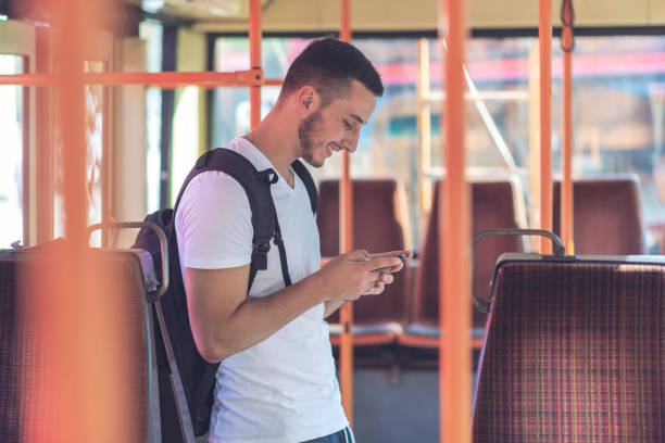 istock Young Man in the Bus with Smart Phone 1067975130