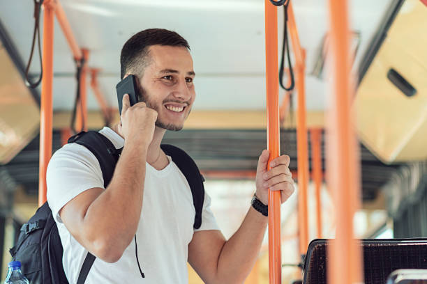 istock Young Man in the Bus with Smart Phone 1067975436