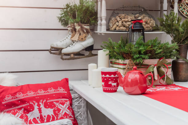 istock Knitted red cup with white reindeer on table with Christmas decoration background, winter morning breakfast concept 1067978980