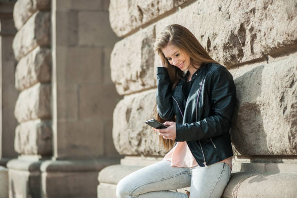 istock Excited student reading news on a smart phone 1067992992