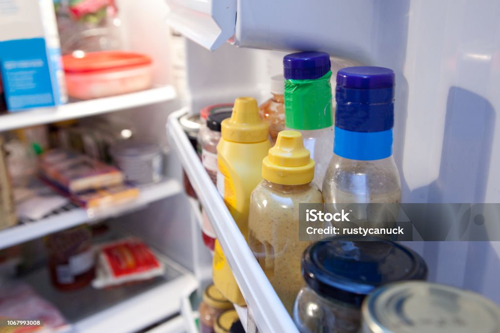 Interior fridge door Bottles and containers inside a fridge Refrigerator Stock Photo