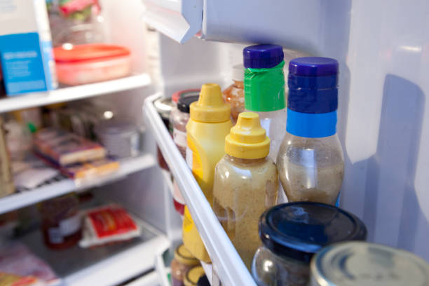Interior fridge door Bottles and containers inside a fridge condiment stock pictures, royalty-free photos & images