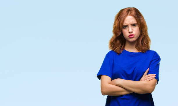 istock Young beautiful woman over isolated background skeptic and nervous, disapproving expression on face with crossed arms. Negative person. 1068003502