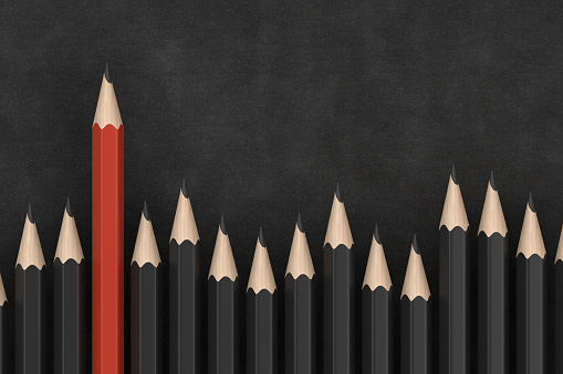 Group of pencil on blackboard, business, standing out from the crowd concept.