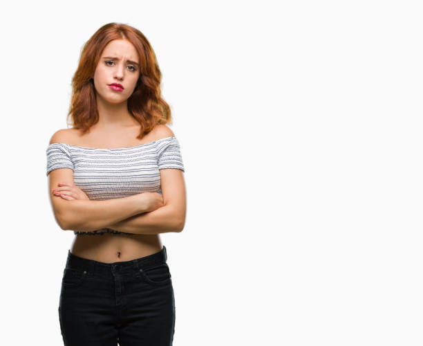 istock Young beautiful woman over isolated background skeptic and nervous, disapproving expression on face with crossed arms. Negative person. 1068006928