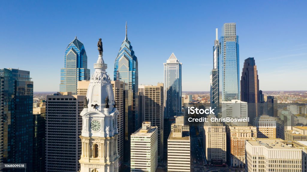 Urban Core City Center Tall Buildings Downtown Philadelphia Pennsylvania Statue of Ben Franklin looks over the city streets of Philadelphia PA Philadelphia - Pennsylvania Stock Photo