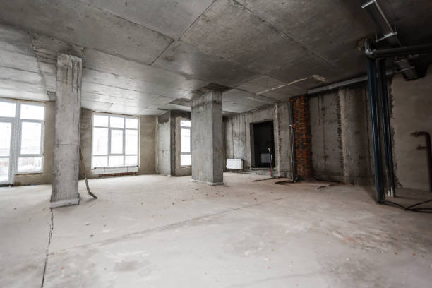 istock Newly renovated generic empty office space with leftover materials and ladder in foreground 1068025052