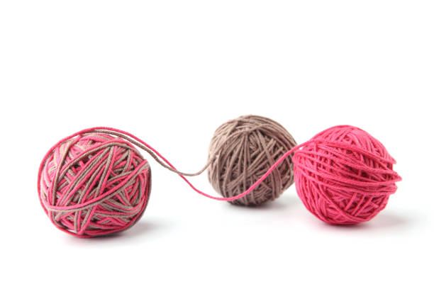 istock Colorful cotton thread ball from two color pink and grey thread  isolated on white background. 1068031316