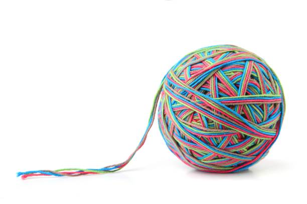 istock Colorful cotton big thread ball from four color thread isolated on white background. 1068031472
