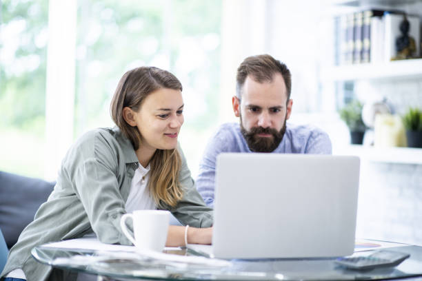 istock Young couple reviewing their personal finances 1068037704